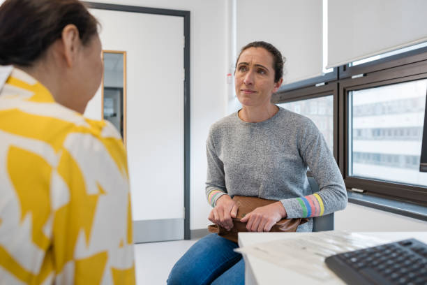 An over the shoulder view of a female consultant discussing requirements with her customer.